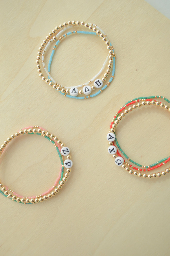 Rep your letters, show your colors, and do it all with style that lasts. 💎  Our Sorority Stacks are built to last — waterproof, tarnish-resistant, and totally chic. 🌊💪 Greek letters + sorority colors = the perfect combo for your forever stack.