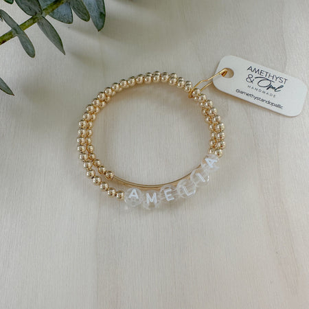 Personalized name + bar bracelet stack. Choose your letter bead color for a fully custom, stackable, everyday bracelet she’ll love.