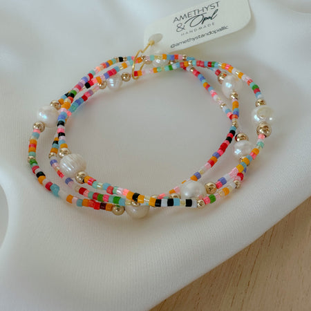Add vibrant summer vibes to your stack with Rainbow Fun Seed Bead Bracelets featuring delicate freshwater pearls.