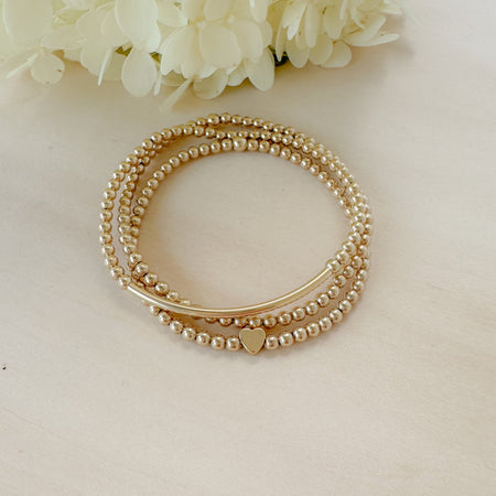 The Golden Lover Stack combines gold-filled bracelets for a stackable, minimalist look that’s timeless, meaningful, and perfect for gifting.