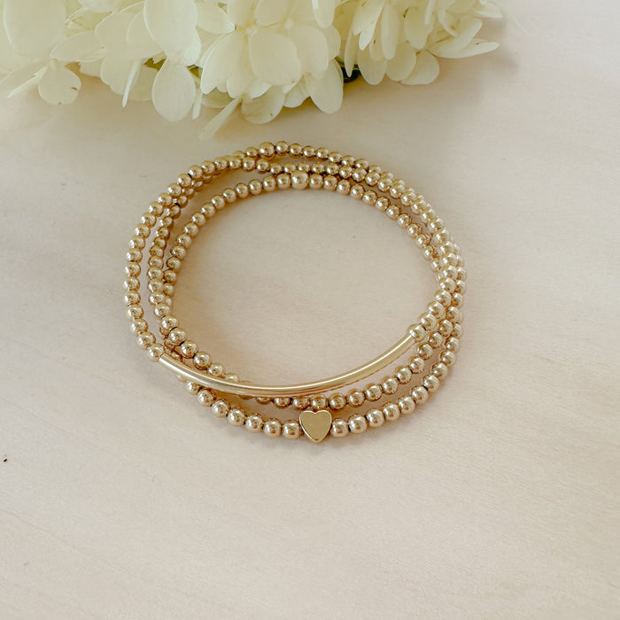 The Golden Lover Stack combines gold-filled bracelets for a stackable, minimalist look that’s timeless, meaningful, and perfect for gifting.