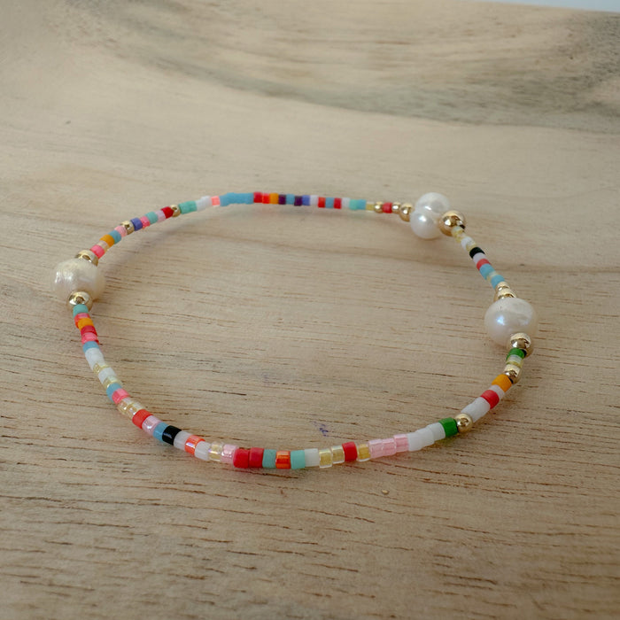Add vibrant summer vibes to your stack with Rainbow Fun Seed Bead Bracelets featuring delicate freshwater pearls.