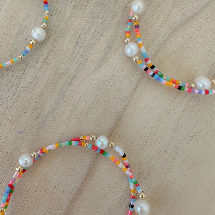 Add vibrant summer vibes to your stack with Rainbow Fun Seed Bead Bracelets featuring delicate freshwater pearls.