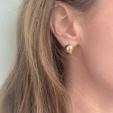Chunky Gold Huggies – tiny, lightweight gold-filled hoops with understated shine. Staff favorite statement earrings perfect for day-to-night wear and stacking.