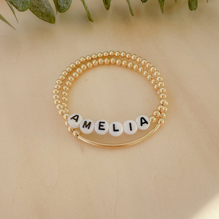 Personalized name + bar bracelet stack. Choose your letter bead color for a fully custom, stackable, everyday bracelet she’ll love.