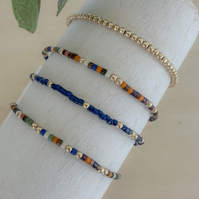 Woodland Bracelet Stack: dainty, layered fall bracelets in warm seasonal colors to brighten jeans-and-T looks or complement autumn outfits.