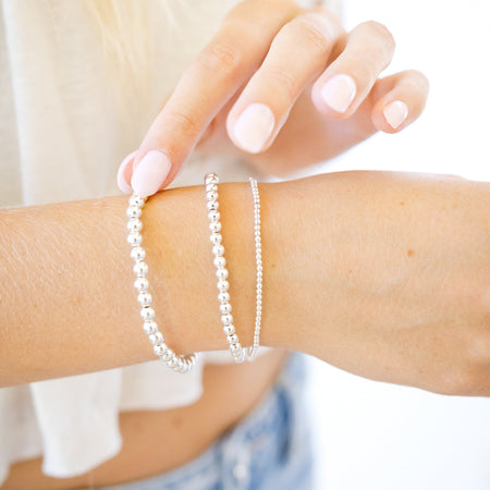set of three sterling silver bracelets three different bead sizes  on wrist 