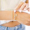 opal white cross on gold beaded bracelet 