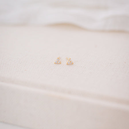 Close-up of a white garment with a gold logo on a blurred background