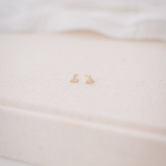 Close-up of a white garment with a gold logo on a blurred background