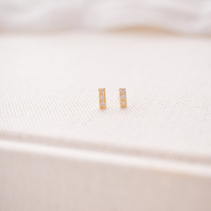 Close-up of a white pillow with a gold emblem on a white background