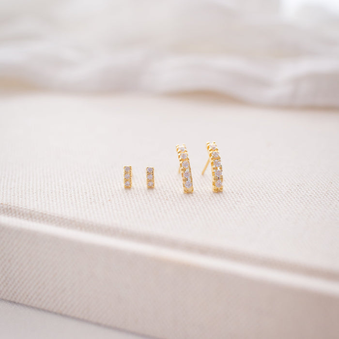 Close-up of a white garment with gold embroidery on a light background