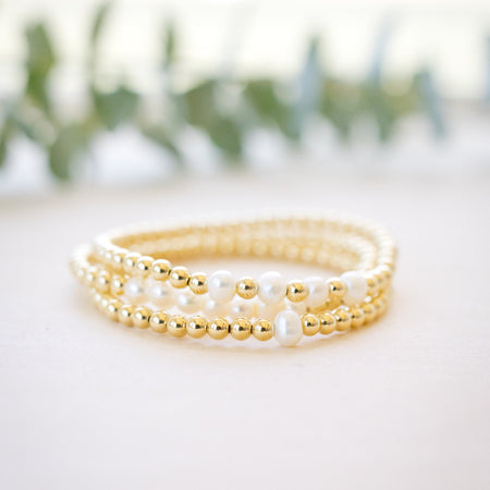 Gold beaded bracelet with freshwater pearl three bracelets stacked up