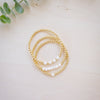 Gold beaded bracelet with freshwater pearl three bracelets stacked up