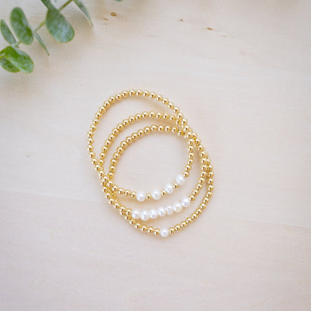 Gold beaded bracelet with freshwater pearl three bracelets stacked up