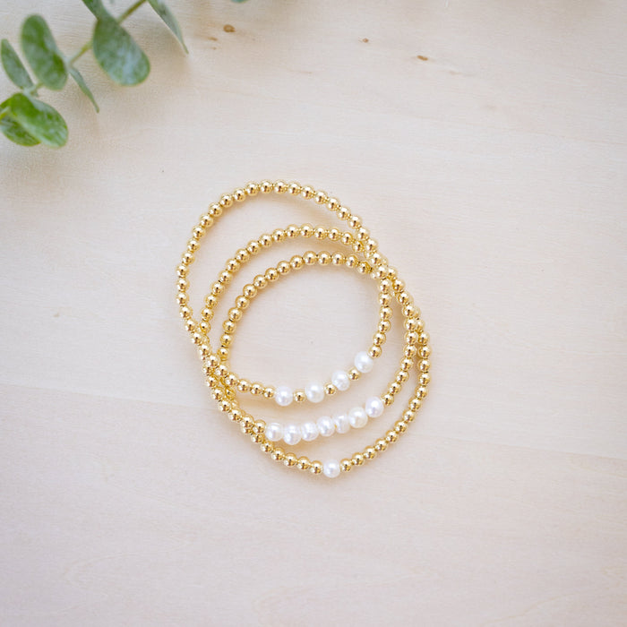 Gold beaded bracelet with freshwater pearl three bracelets stacked up