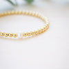 Gold beaded bracelet with single freshwater pearl 