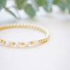 Gold beaded bracelet with single freshwater pearl  close up 