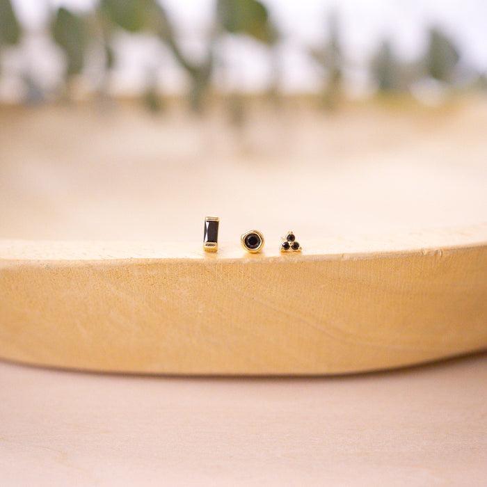 two onyx earring studs in ear