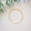 Gold beaded bracelet with freshwater pearl flatay seven pearls in a row