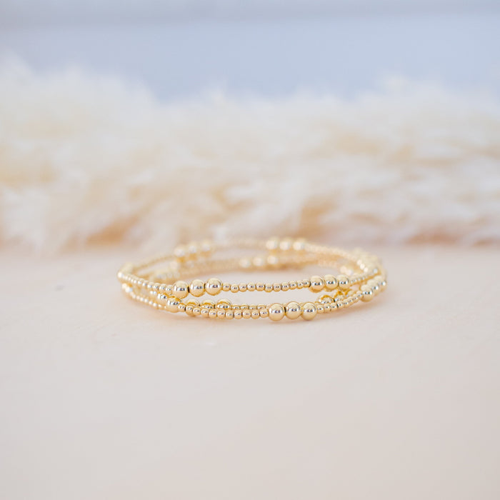 Gold ring on a textured white surface
