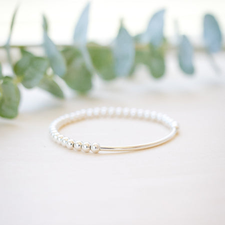 silver beaded bar bracelet on neutral background 