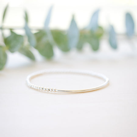 silver beaded bar bracelet on neutral background 