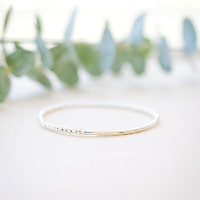silver beaded bar bracelet on neutral background 