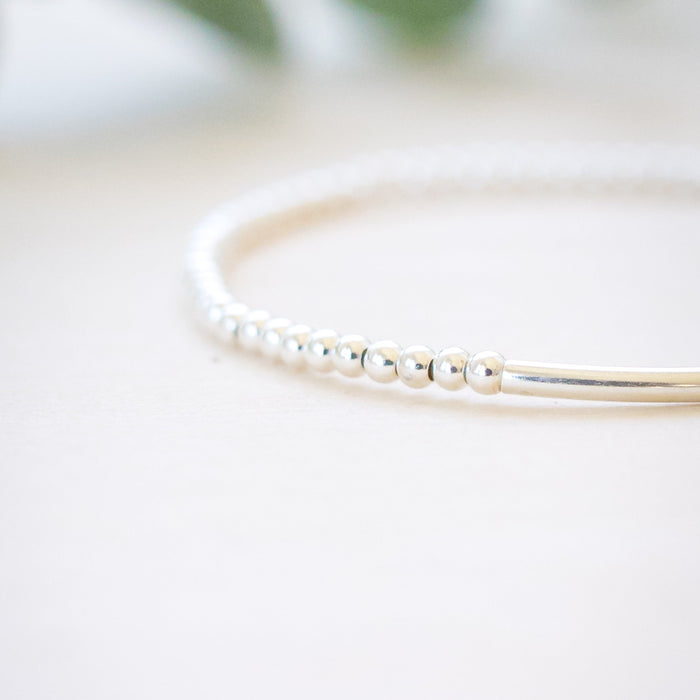 silver beaded bar bracelet on neutral background 