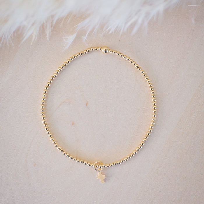Gold bracelet on a light background