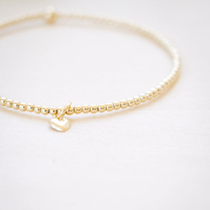 tiny beaded bracelet with tiny heart charm 