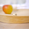 gold filled apple stud with apple in background