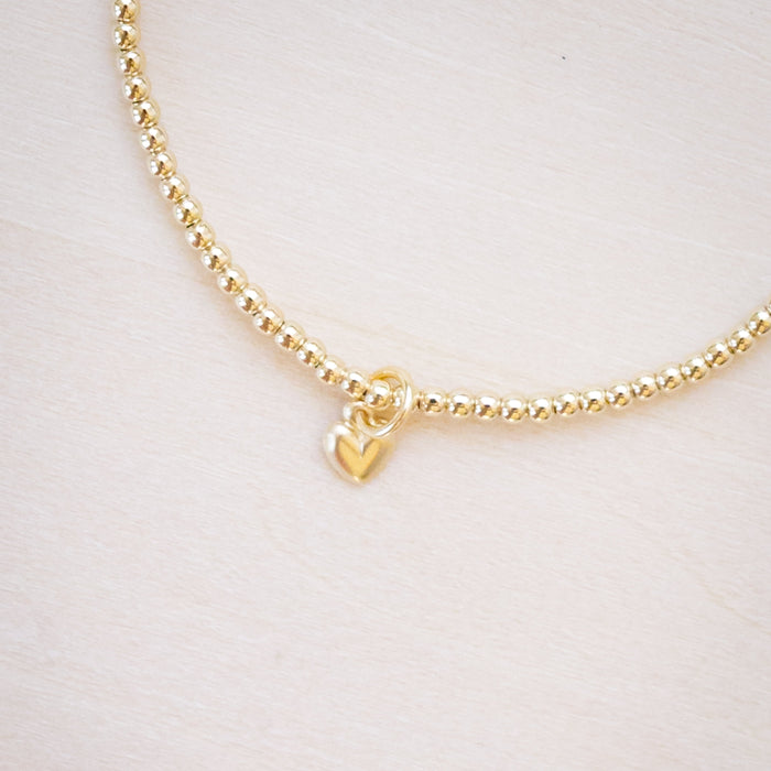 tiny beaded bracelet with tiny heart charm 