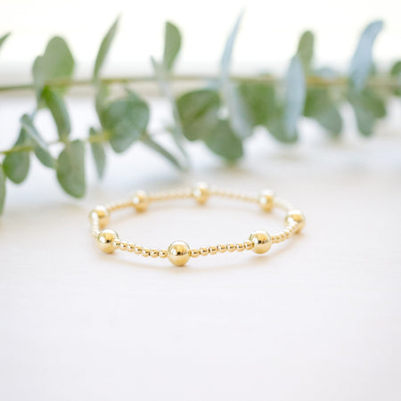 gold beaded bracelet with two size gold beads 
