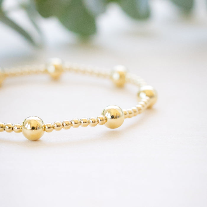 gold beaded bracelet with two size gold beads 