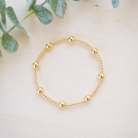gold beaded bracelet with two size gold beads 