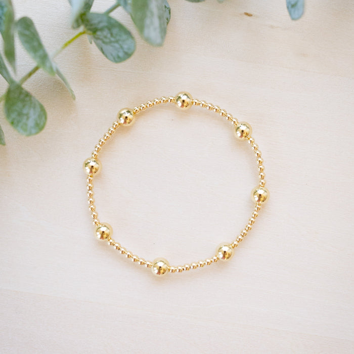 gold beaded bracelet with two size gold beads 