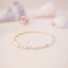 Delicate bracelet with small beads on a soft, blurred background