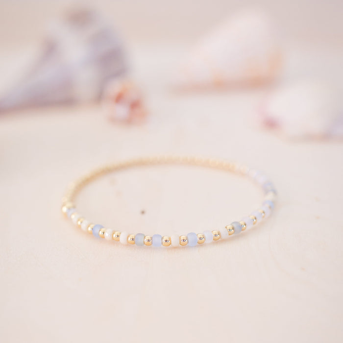Delicate bracelet with small beads on a soft, blurred background