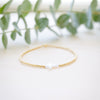 opal white cross on gold beaded bracelet front angle 