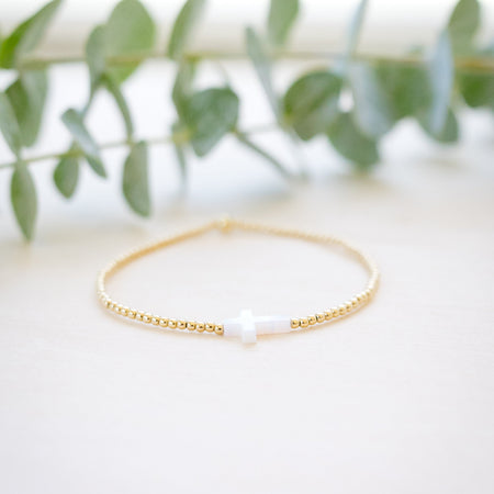 opal white cross on gold beaded bracelet front angle 