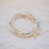 Set of three beaded bracelets on a textured surface