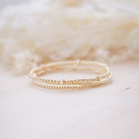 gold beaded bracelet stack with gorgeous textureed bead for light