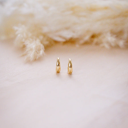 tiny drop huggies for second holes on  wood background