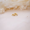 tiny drop huggies for second holes on  wood background