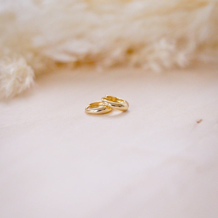 tiny drop huggies for second holes on  wood background