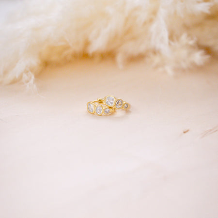 hazel gemstone huggies on wood background