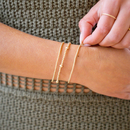 gold beaded bracelet stack with gorgeous textureed bead for light