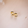 shiny gold fat huggies on wood background, shwoing closure