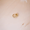 tiny huggies with gold ball texture on wood background